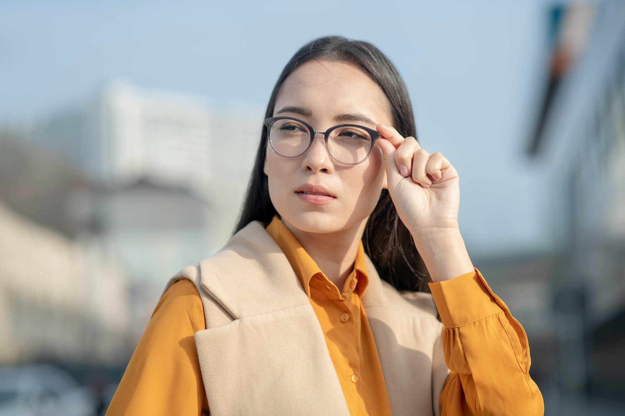 Young asian pretty woman holding her eyeglasses